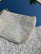 beige toilettas met zeester sleutelhanger